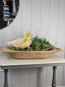 Antique Wooden Dough Bowl, with bristle goose, Snowdrops and twigs displayed inside.