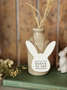 Ceramic bunny shaped hanging decoration, with saying "follow the bunny he has chocolate " stamped on to it. 